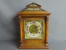 Polished steeple topped bracket clock with brass face