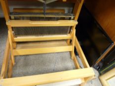 Harris weaver's loom and a small Samsung flatscreen TV with remote control E/T