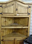 Rough pine standing corner cupboard, possibly Continental, having a domed top with two high