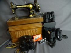Cased hand cranked Singer sewing machine along with three pairs of binoculars to include Mark