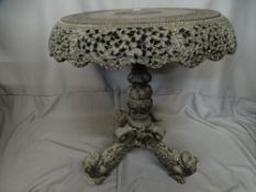 Burmese carved tilt top occasional table on tripod dragon decorated supports, 56 cms diameter