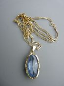 Nine carat gold necklace of oblong links with nine carat gold oval pendant and large blue stone, 8.5