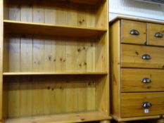 Modern pine open bookcase and a similar narrow chest of five drawers