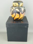 Okra Studio glass ginger jar and cover, stylized cameo type leaves on a mottled orange ground, 16.
