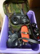 Two Army gas masks and a pair of 8x30 field binoculars (cased)
