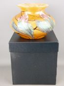 Okra Studio glass squat vase having stylized iridescent flowers against a mottled body, 13 cms high,