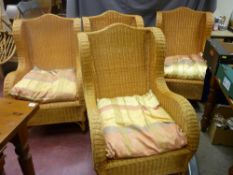 Set of four good wingback wicker armchairs with shaped back detail, 104 cms high, 67 cms wide, 58