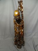 Well carved Shaolin figurine with smaller figure at heel, on a carved shaped base, approximately 110