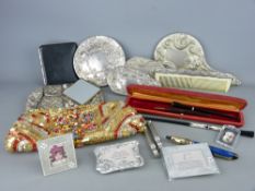 Audrey Hepburn style cigarette holder and one other, two EPNS dressing table part hand mirror