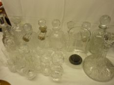 Collection of cut and other glass decanters with stoppers and a selection of drinking glassware etc