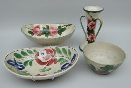 A LLANELLY POTTERY GROUP OF FOUR comprising tri-handled waisted vase painted with tea-roses, 21cms