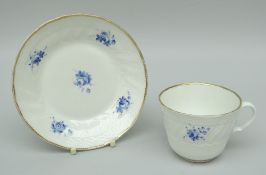 A SWANSEA PORCELAIN CUP & SAUCER with moulded basket-weave border, swirl moulded border, dentil gilt