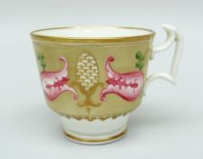 A SWANSEA CUP decorated with pink flowers and gilded finials in a brown reserve (no saucer)