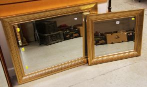A PAIR OF MODERN GILT-FRAMED WALL MIRRORS
