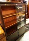 A VINTAGE SLIDING DOOR OFFICE BOOKCASE with cupboard base