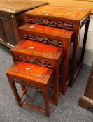 A NEST OF FOUR ORIENTAL STYLE TABLES in burr-wood and with carved friezes