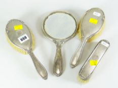 FOUR PIECE SILVER VANITY SET comprising three brushes and a mirror with engraved initials,