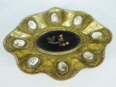 AN ITALIAN GILT METAL DISH of flared form and bejewelled with a series of eight cameos to the border