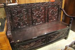 A REPRODUCTION CARVED BOX-SEAT SETTLE