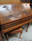 AN ORIENTAL CARVED HARDWOOD SLOPED BUREAU with two drawers and matching stool