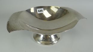 WHITE METAL PROBABLY CONTINENTAL SILVER PEDESTAL BOWL with twin handles in beaten effect