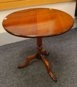 A CIRCULAR TOP TILTING TRIPOD TABLE