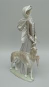 A LLADRO FIGURE OF A FEMALE wearing a scarf, walking her borzoi dog on a windy day 39cms high