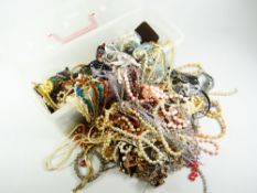 COSTUME DRESS JEWELLERY, a plastic container full and including beads, earrings, necklaces, bangles,