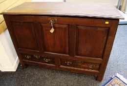 A C19TH LANCASHIRE CHEST having a three panel frontage, two drawers and hinging lid on style feet,