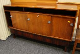 A MID-CENTURY DANISH-STYLE SIDEBOARD raised on square supports, with three sliding doors and full