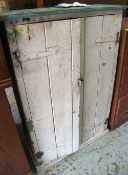 A DISTRESSED PAINTED PINE TWO-DOOR CUPBOARD