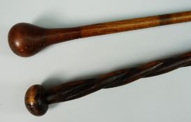 A CARVED WOODEN KNOBKERRIE-type stick with brass terminal together with a possibly South African