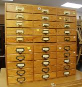A GOOD PAIR OF PINE INDEX DRAWER CHESTS composed of three tiers of five drawers