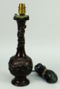 AN ORIENTAL BRONZE BOTTLE VASE converted to table lamp use, decorated in relief with flora and fauna