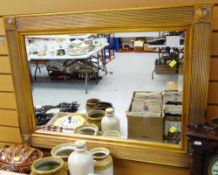 A MODERN GILT FRAMED BEVELLED WALL MIRROR