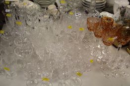 A GOOD ASSEMBLAGE OF QUALITY CUT GLASS DRINKING ITEMS including two decanters, tinted hock glasses