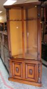 A CONTINENTAL STANDING CORNER CABINET