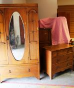 A VINTAGE OAK THREE-PIECE BEDROOM SUITE comprising mirrored single wardrobe with base drawer,