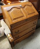 A REPRODUCTION THREE-DRAWER SLOPED BUREAU together with a reproduction magazine rack, a stick