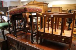 A REPRODUCTION CANTERBURY with single drawer, a canework stool, another stool and a carved oak