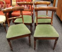 A SET OF FOUR ANTIQUE DINING CHAIRS with green velvet seats, with bentwood backs and on turned front