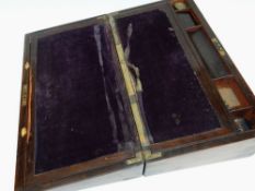 AN ANTIQUE ROSEWOOD LAP-DESK having brass fittings, the interior with original felt-lined writing