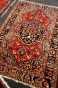 A GOOD PERSIAN WOOL CARPET with multicoloured floral medallion design, 206 x 143cms