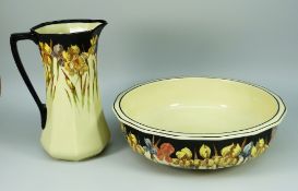 A GOOD ROYAL DOULTON POTTERY TOILET JUG AND BASIN decorated with flowers; basin 42cms high, jug