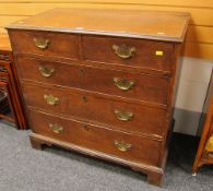 AN ANTIQUE OAK CHEST of three long and two short drawers, having original brass handles and on