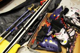 TWO SETS OF ROLLERBLADES & A CANVAS CARRIER containing skis and poles