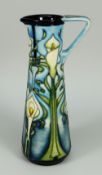 A MOORCROFT POTTERY SLENDER JUG in the 'Calla Lily' pattern circa 2002, 24cms high (boxed)