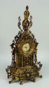 A REPRODUCTION FILIGREE GILT METAL MANTEL CLOCK