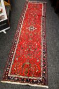 A PERSIAN CARPET RUNNER with large floral centred design, 300cms long