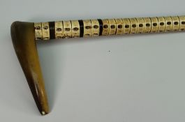 A C19TH MARINE VERTEBRAE WALKING STICK with horn handle 89cms long